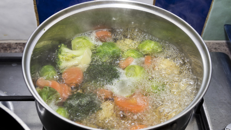 assorted vegetables in boiling pot of water