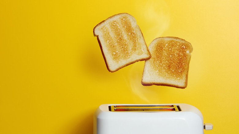 toasted white bread toaster yellow background