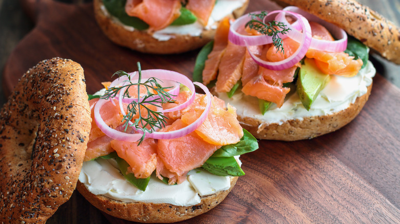 Everything bagels with cream cheese, lox, onions, and dill