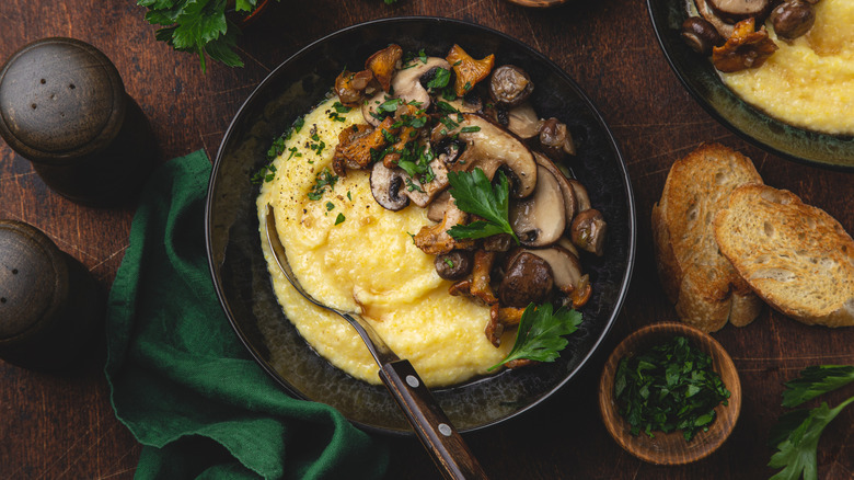 Polenta in black bowl with mushrooms