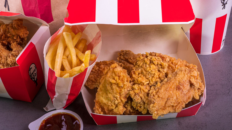 KFC chicken, French fries, and red dipping sauce