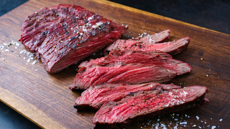 Flap steak cut and presented on plate with salad