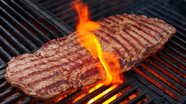 Flap steak on a fiery grill