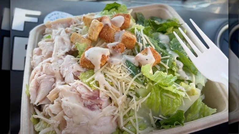 Costco chicken caesar salad in disposable bowl