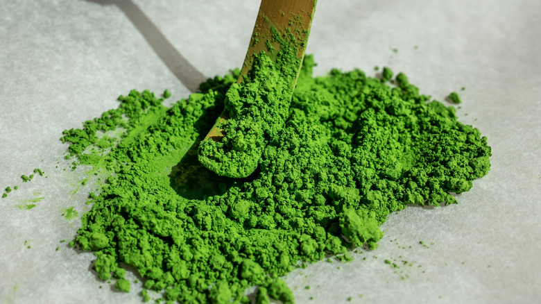 matcha green tea powder with a bamboo spoon