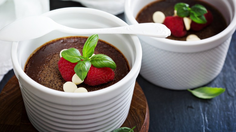 Pots de creme in ramekins with raspberries