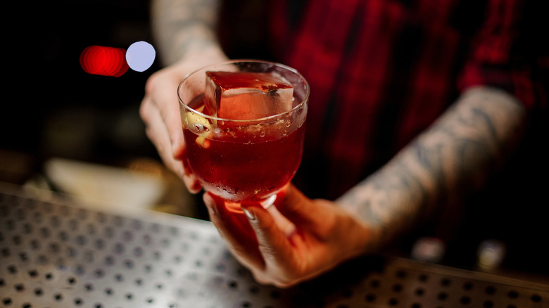 Person serving a Creole Cocktail