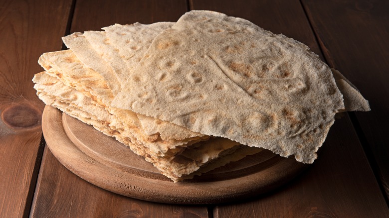 pane carasau over wood cutting board on a wood surface