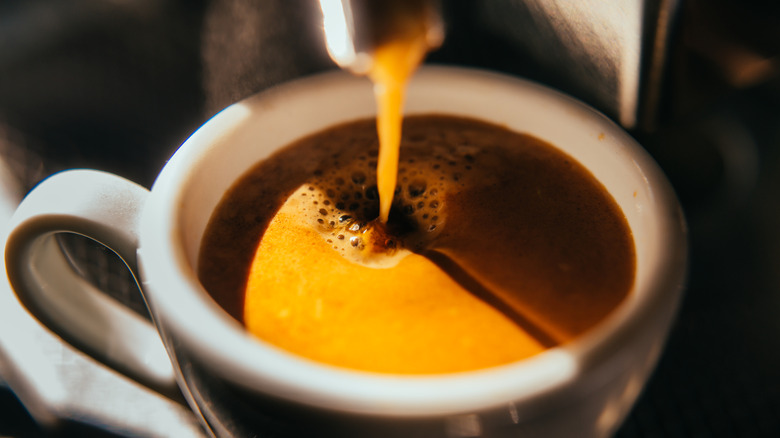 A machine pouring an espresso.