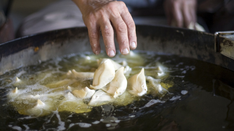 Frying samosas in oil 