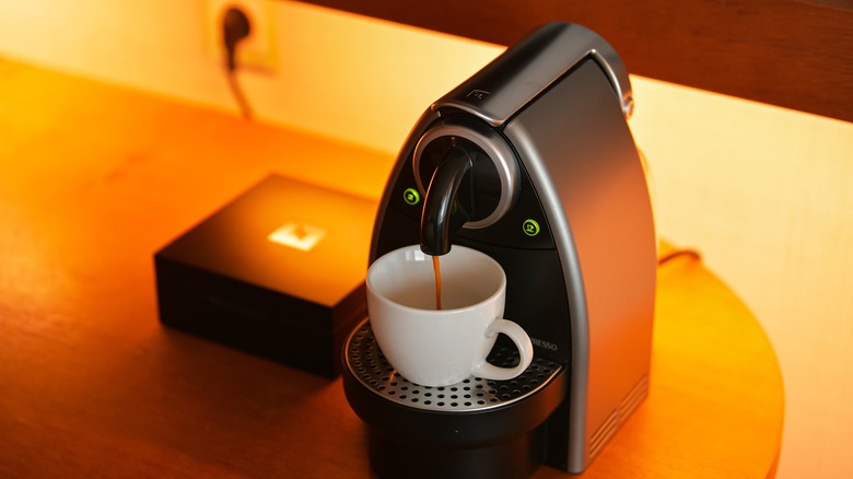 A Nespresso machine making a coffee.