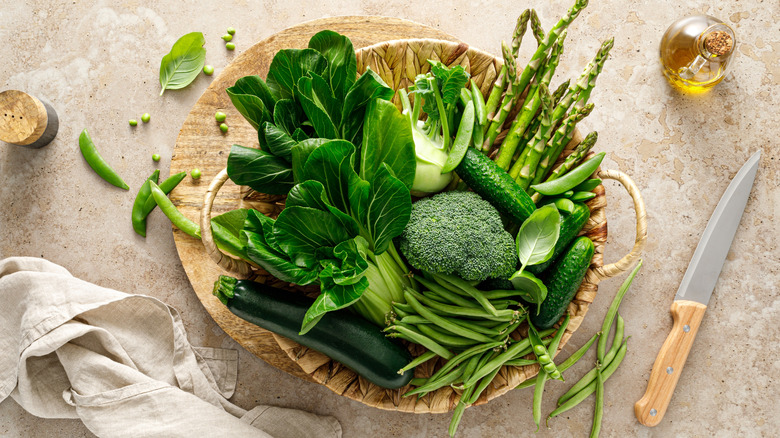 a wooden bowl of green vegetables