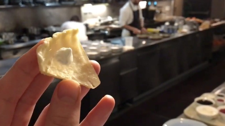 someone holding a mini spice of clear pumpkin pie