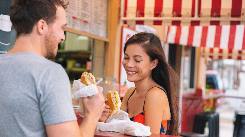 Couple eating Cuban Sandwiches