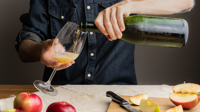 Apple cider pours from bottle