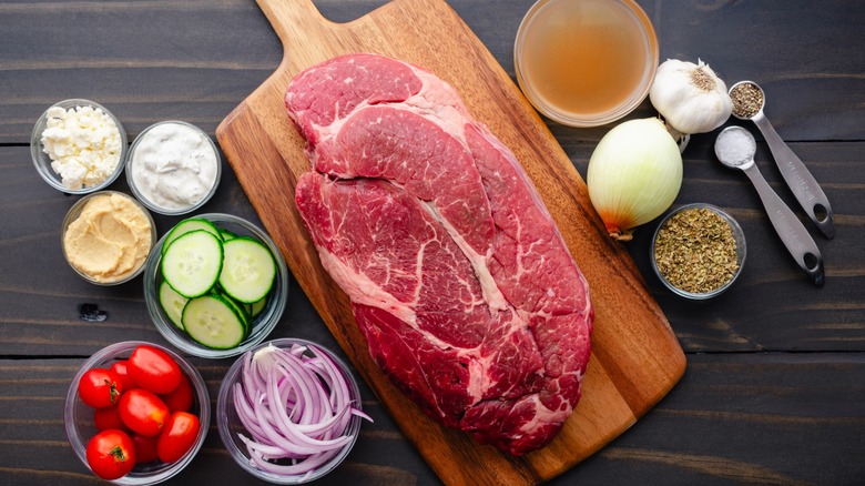 cut of chuck roast and condiments for cooking