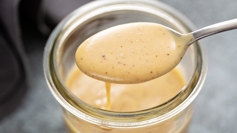 Sauce in jar with spoon