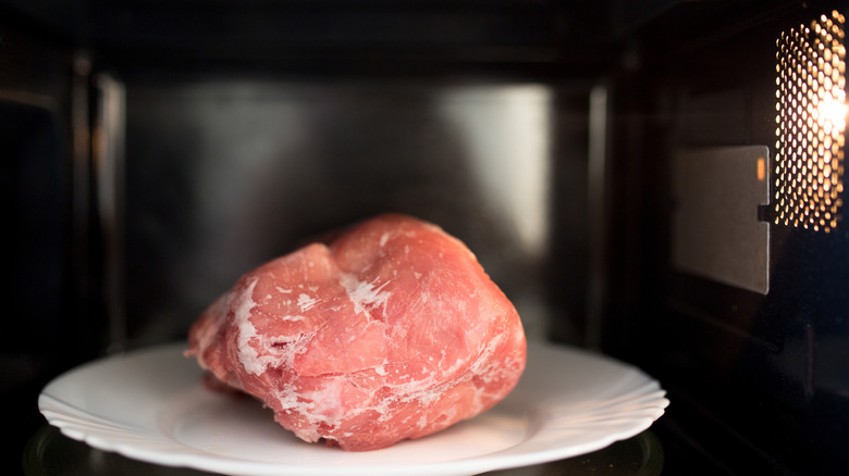 Defrosting meat in microwave oven 