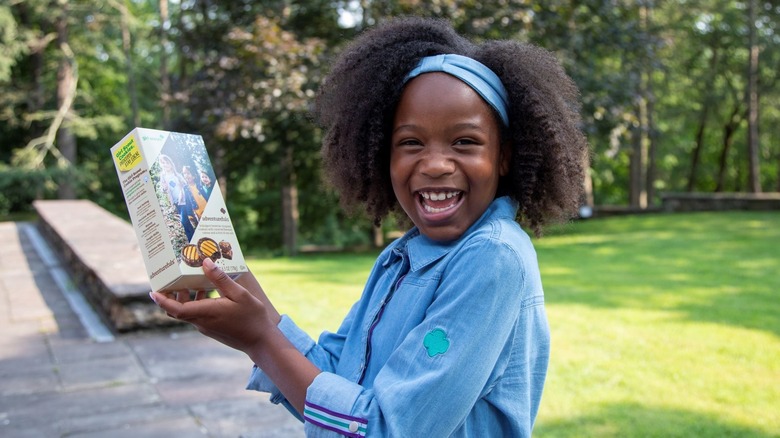 Girl Scout holding a box of new Adventurefuls