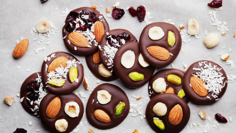 French chocolate mendiants topped with nuts, cranberries, and coconut