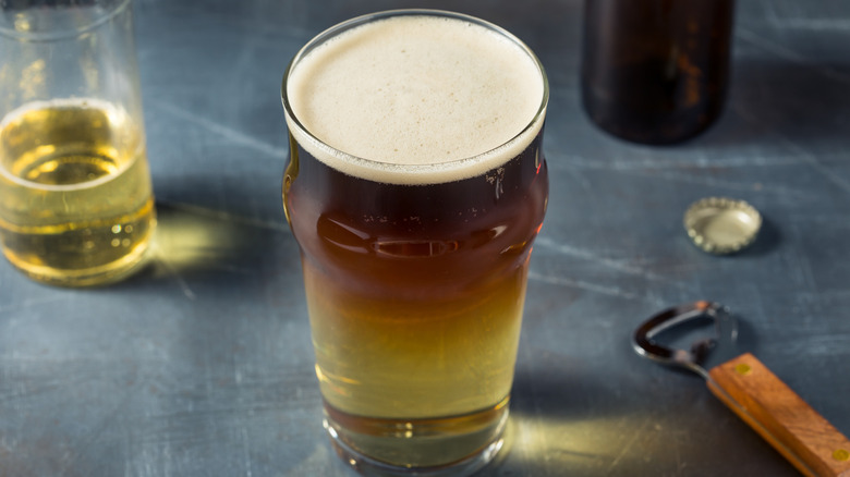 Snakebite cocktail in a pint glass