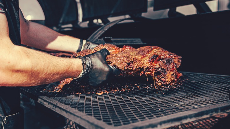 Placing meat in a smoker