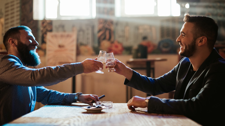 two men drinking bourbon