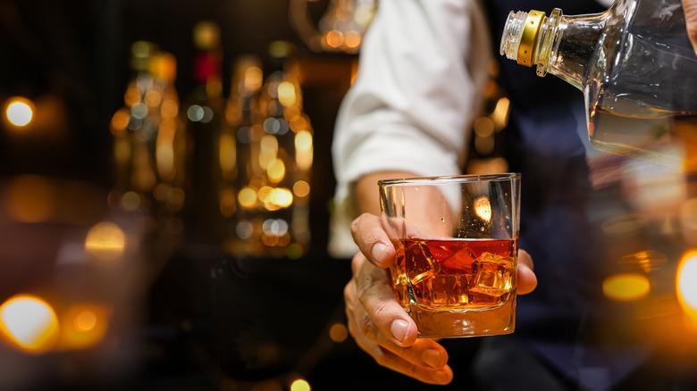 bartender pouring bourbon