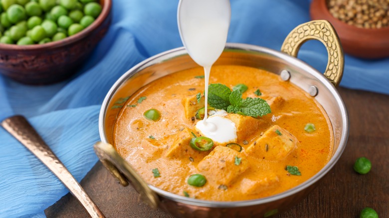 Pouring heavy cream onto food