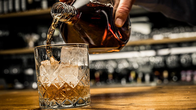 whiskey being poured into glass