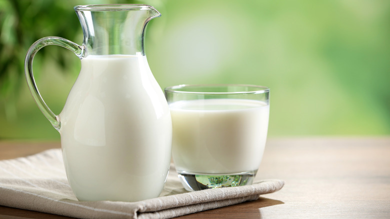 glass milk pitcher and glass of milk