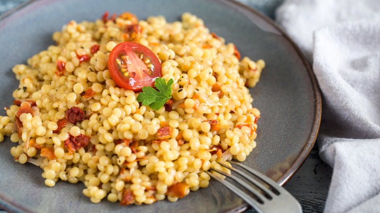 bowl of Israeli couscous with tomatoes and herbs