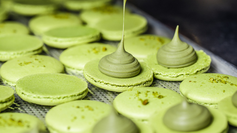 baker filling pistachio macarons