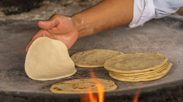 Fresh corn tortillas on griddle