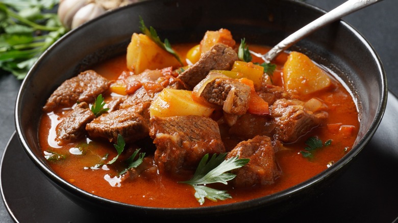 A meat dish with red paprika sauce in a pan