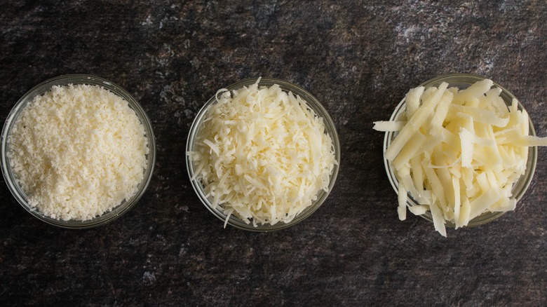 Shredded and grated cheeses in ramekins 