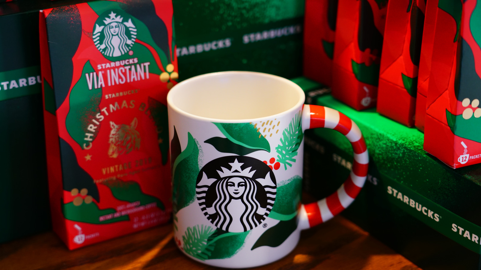 Starbucks Christmas espresso cups next to Nespresso machine