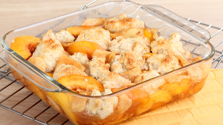 Traditional peach cobbler in glass dish