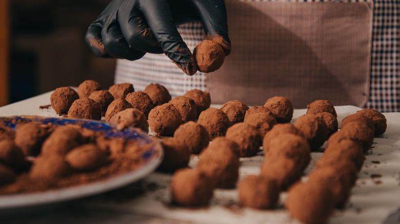 Person making chocolate truffles