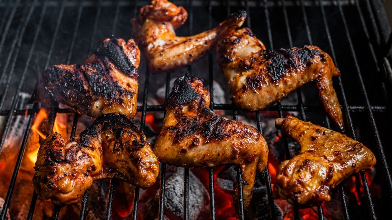 Whole chicken wings on grill