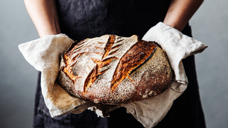 Person holding sourdough loaf