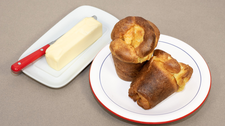 Popovers on a plate with butter