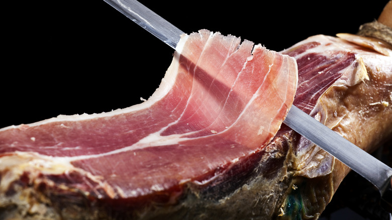 slicing prosciutto