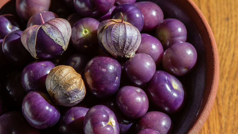 purple tomatillos in a bowl