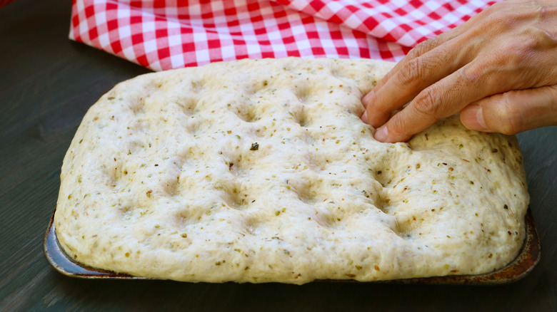 Adding dimples to focaccia bread 