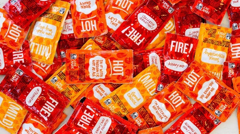 pile of Taco Bell hot sauces