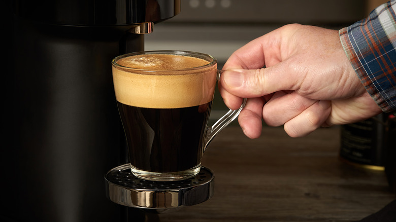 A person brewing coffee