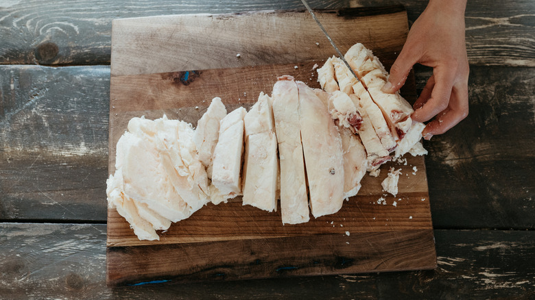 cutting up beef tallow on a cutting board