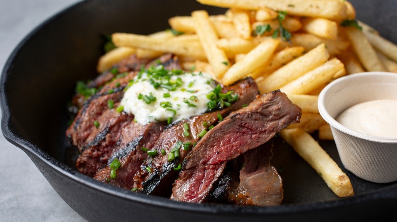 steak frites in an iron pan