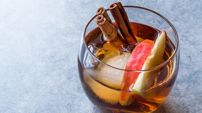 Cold toddy with cinnamon sticks